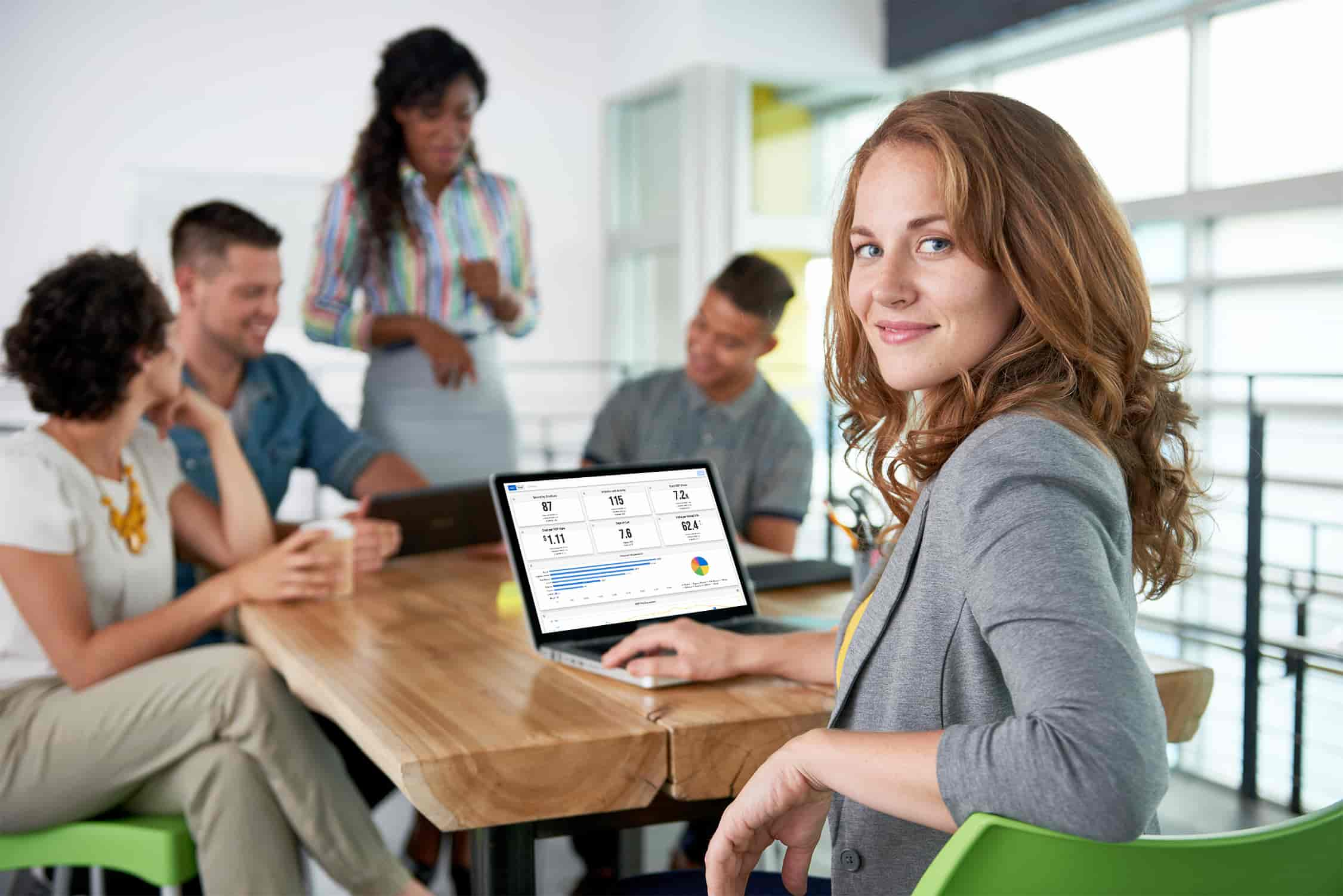 Women at agency with MarketAI on laptop screen