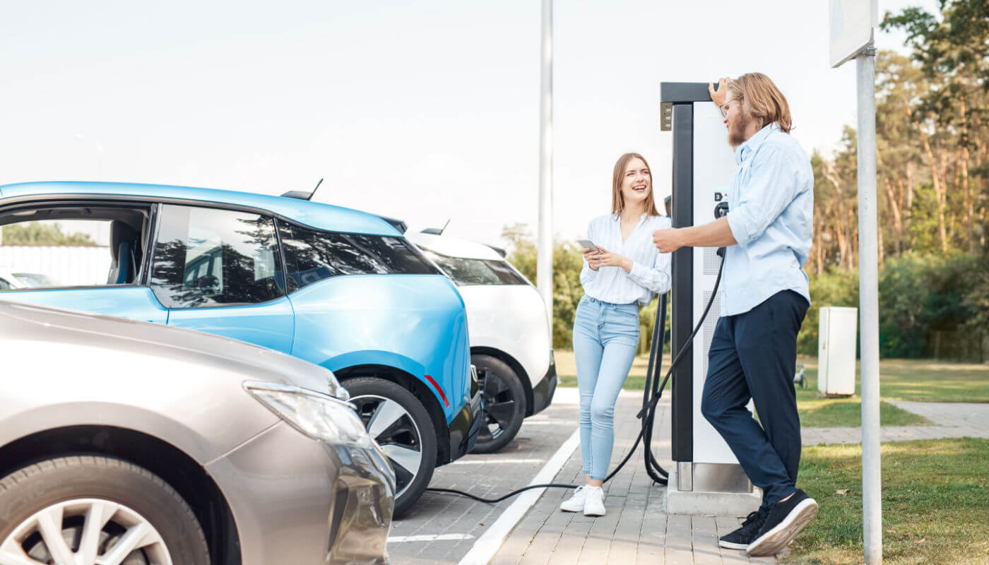 customers at electric vehicle charging station