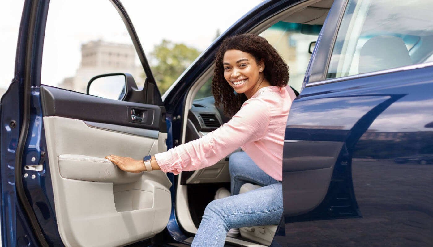 woman leaving car dealership