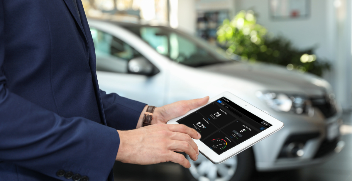 car dealer using car dealership software solution on ipad inside a dealership